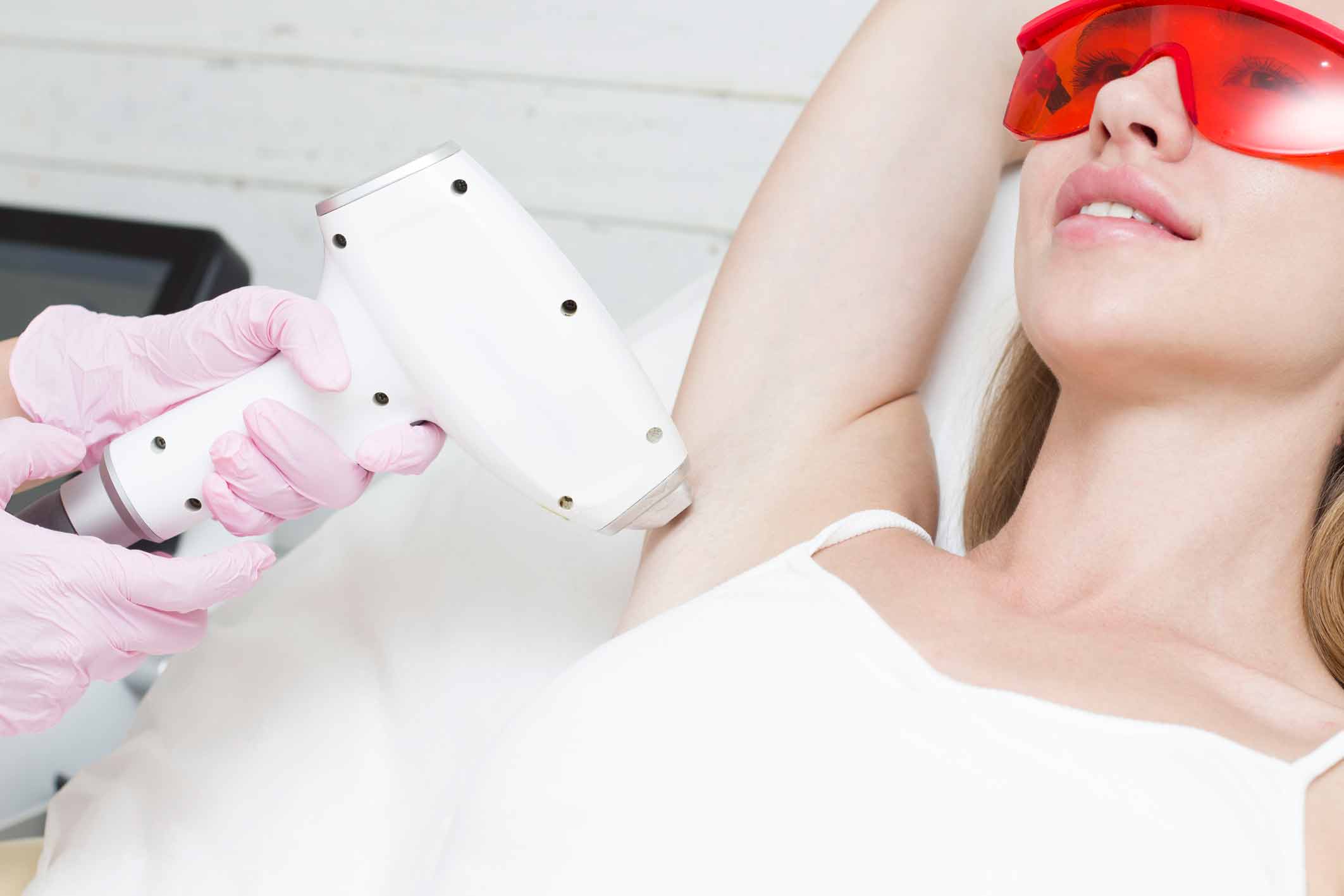 young blonde woman undergoes procedure laser hair removal her armpits beauty clinic